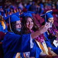 students taking a selfie at a graduation