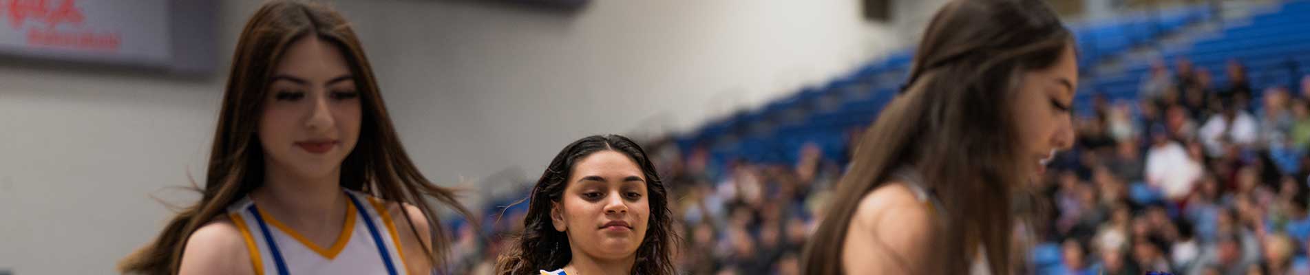 Three cheerleaders at a game