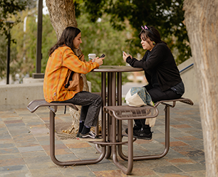 Two students having lunch outside on campus grounds